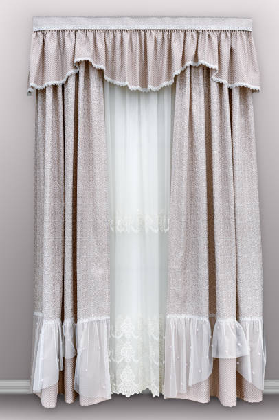 istock Decorating windows with fabric in a classic style. Dense curtains made of natural cotton material with a geometric pattern, soft pelmet and light translucent tulle. 1061610472