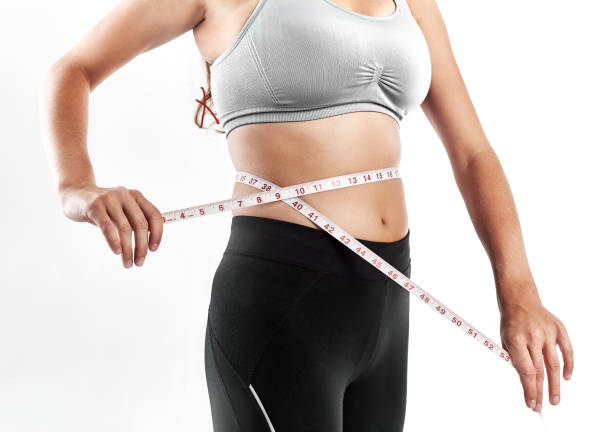 istock Vital statistics: young woman taking her own measurements 1061617394