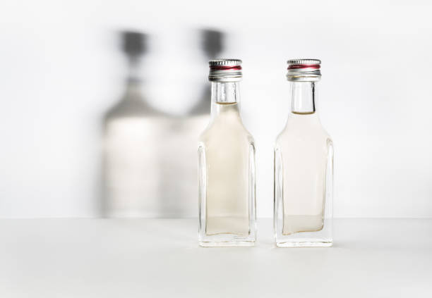 Two bottles of vintage alcohol with shadows on the wall. The concept of communication, friendship and good company