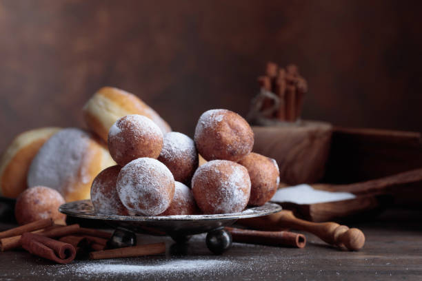 istock Sweet donuts with cinnamon sticks powdered with sugar. 1061625360