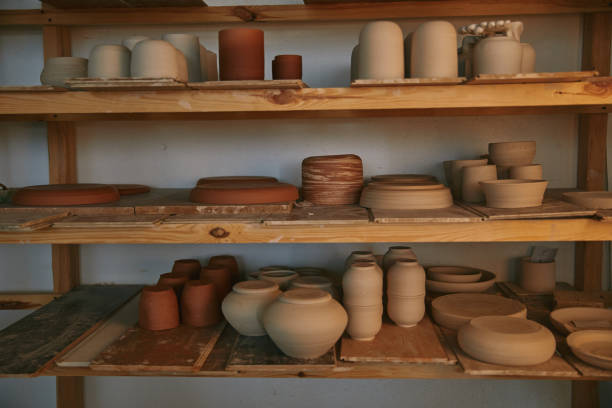 istock ceramic bowls and dishes on wooden shelves at pottery studio 1061625700