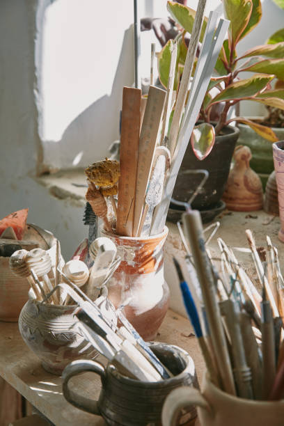istock selective focus of pottery tools and paintbrushes at table in pottery studio 1061625706