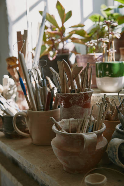 istock selective focus of pottery tools and paintbrushes at table in pottery studio 1061625718