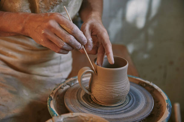 istock partial view of professional potter decorating clay pot at workshop 1061625736