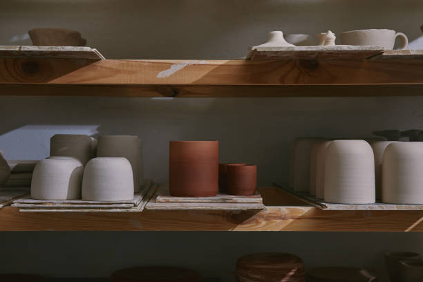 istock ceramic bowls and dishes on wooden shelves at pottery studio 1061625778