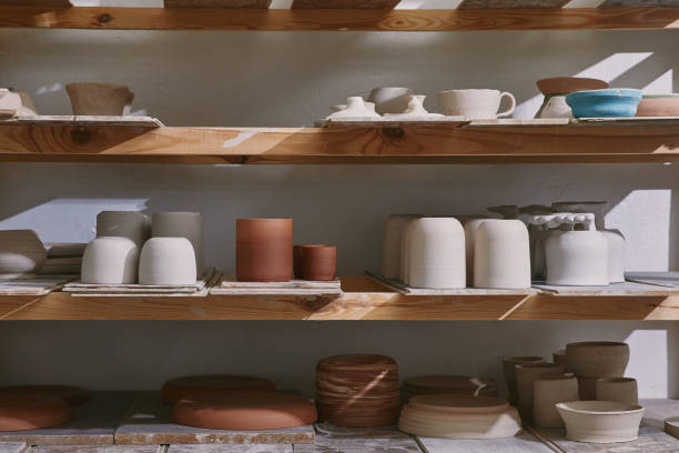 istock ceramic bowls and dishes on wooden shelves at pottery studio 1061626820
