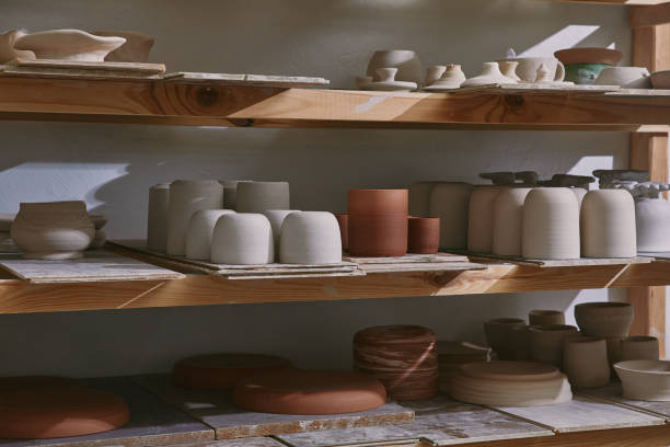 istock ceramic bowls and dishes on wooden shelves at pottery studio 1061626874