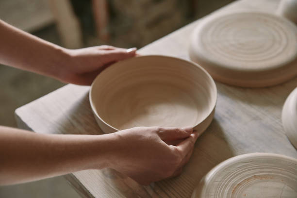 istock partial view of woman putting ceramic dish on table at workshop 1061627134