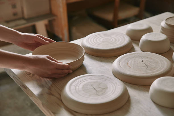 istock partial view of woman putting ceramic dish on table at workshop 1061627140