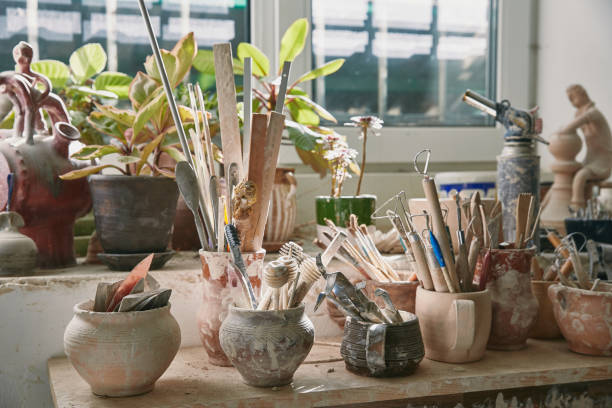 istock selective focus of pottery tools and paintbrushes at table in pottery studio 1061627176