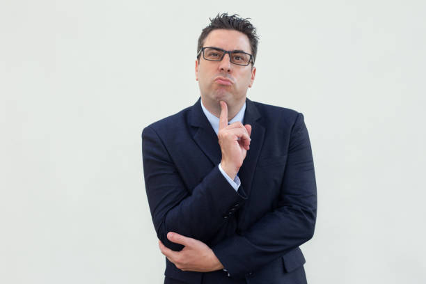 istock Pensive successful businessman in suit looking at camera 1061627304