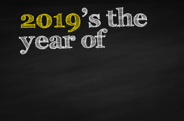 2019 is the year of Picture showing a black chalkboard with white and yellow text. 2019 new year resolution stock pictures, royalty-free photos & images