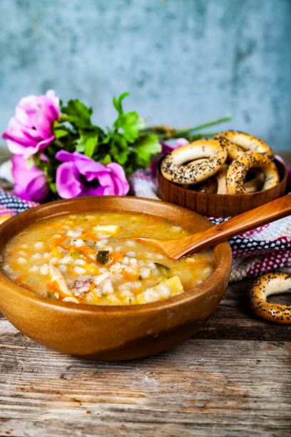 istock Pickle soup on old wooden table. 1061630142