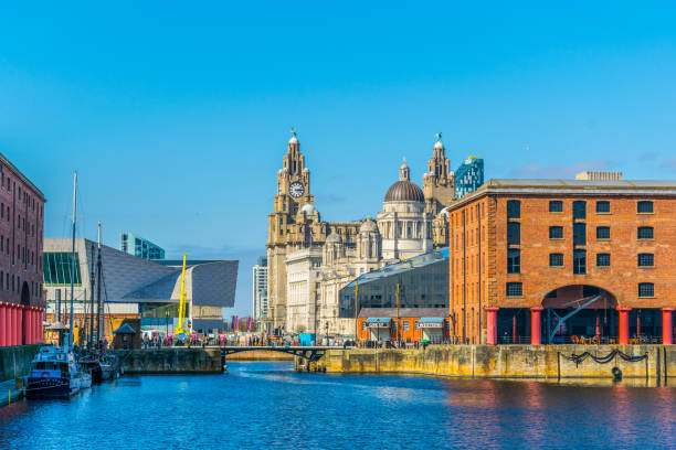 skyline of liverpool through albert dock, england - liverpool imagens e fotografias de stock