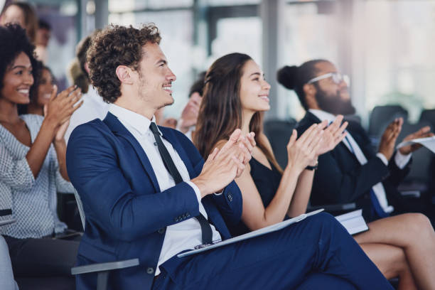 They don't just applaud for anything Low angle shot of a group of businesspeople applauding during a seminar in the conference room awards ceremony photos stock pictures, royalty-free photos & images