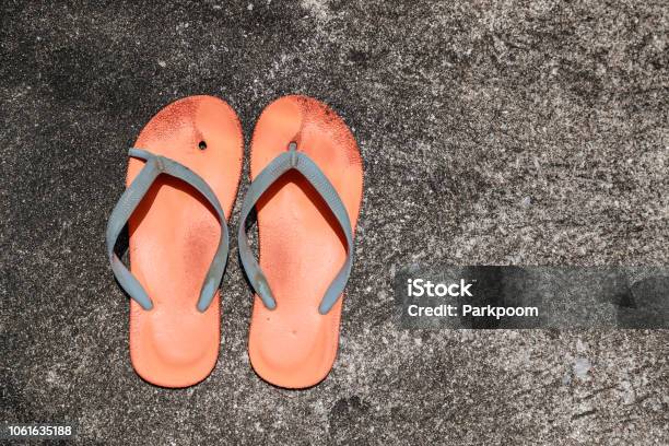 Old And Broken Orange Flip Flops On Street Stock Photo - Download Image ...