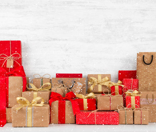 istock Christmas Gift Boxes on White Wooden Table 1061635646