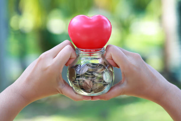 istock human hands saving money and do heart symbol sign 1061642820