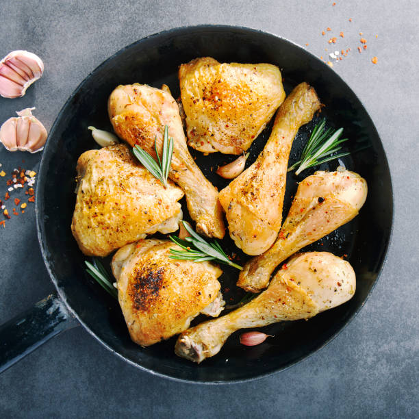 istock Tasty baked chicken legs with spices on pan 1061642970