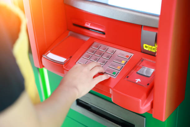 istock human hand pressing keypad ATM/ bank machine 1061645176