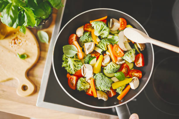 istock Man cooking fresh vegetables in pan 1061645200