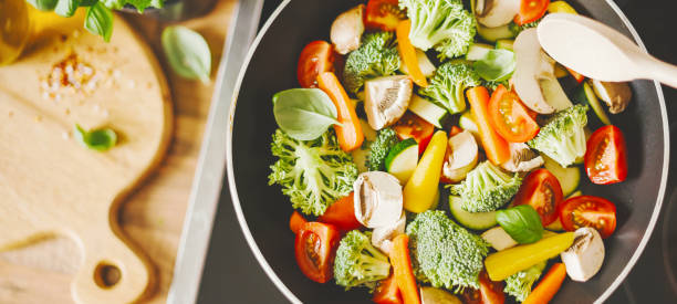 istock Man cooking fresh vegetables in pan 1061645230