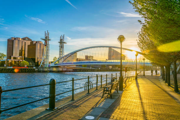 View of a footbridge in Salford quays in Manchester, England View of a footbridge in Salford quays in Manchester, England quayside photos stock pictures, royalty-free photos & images