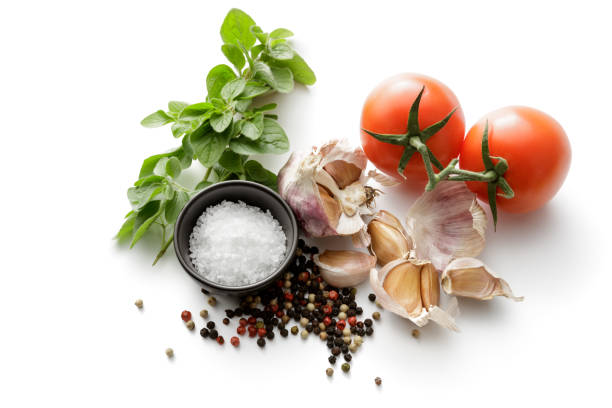 istock Seasoning: Tomatoes, Salt, Garlic, Oregano and Pepper Isolated on White Background 1061648062