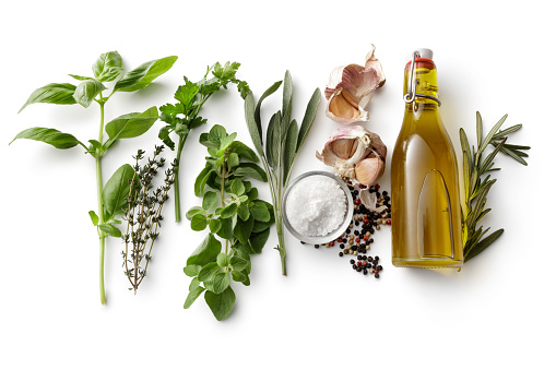 Seasoning: Fresh Herbs, Olive Oil, Garlic, Salt and Pepper Isolated on White Background
