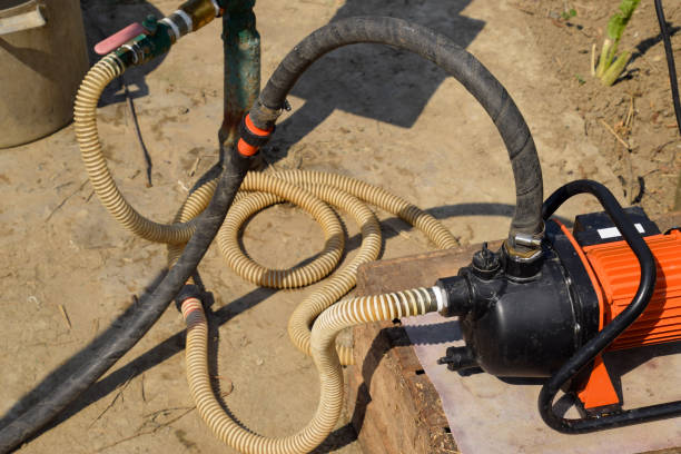 istock Self-priming garden pump and hose system connected to it. 1061649504