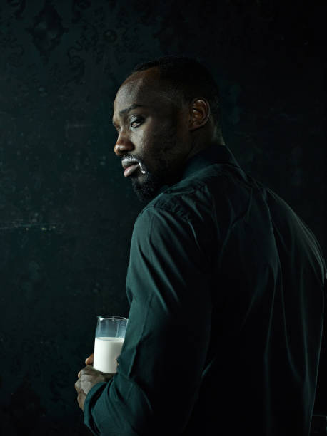 istock Healthy young african man holging milk 1061649518