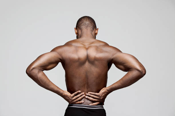 istock Young man with back pain isolated on white 1061649552