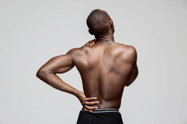 istock Young man with back pain isolated on white 1061649574