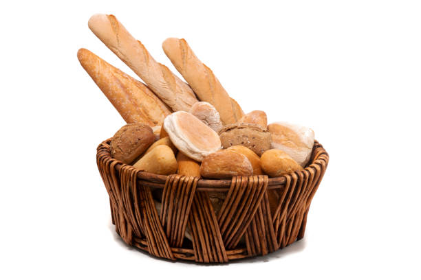 Fresh Assortment of several baked bread varieties inside a wicker basket.