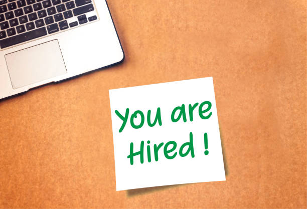 istock You are Hired on sticky note and laptop on table 1061655510