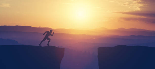 istock Man running towars cliff in the mountains. 1061655978