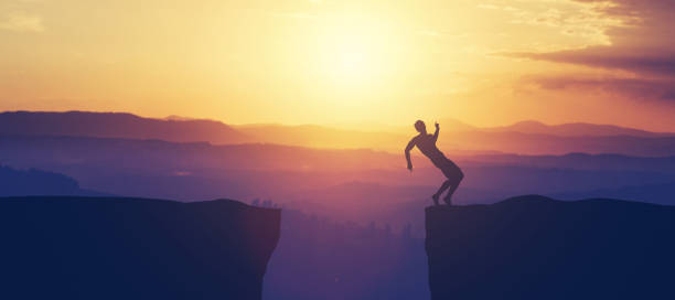 istock Man trying to keep balance on the cliff. 1061655984