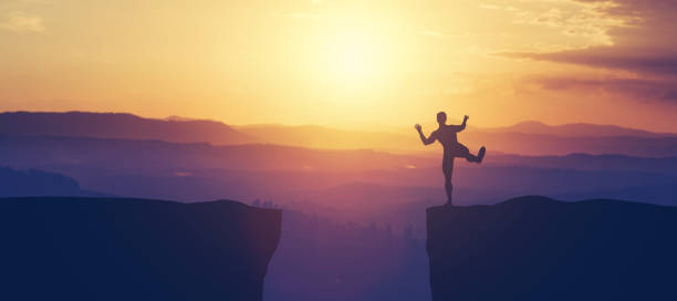 istock Man balancing on the edge of a cliff. 1061655994