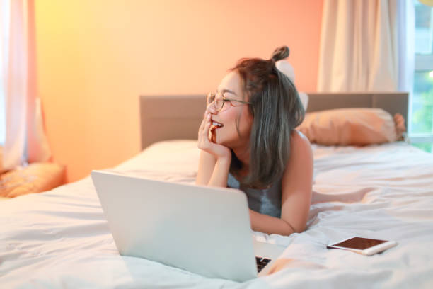 istock beautiful and sexy woman using laptop computer before go to sleep 1061657640