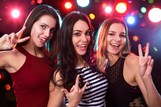 istock Happy girls fun dancing at a party 1061658344