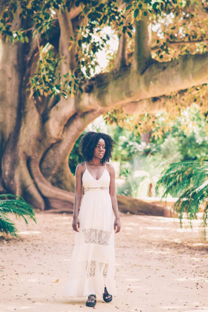 istock Serious young attractive black woman walking in park 1061658832