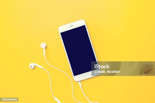 Smart Phone On Yellow Stock Photo - Download Image Now - Headphones, Smart Phone, Mobile Phone