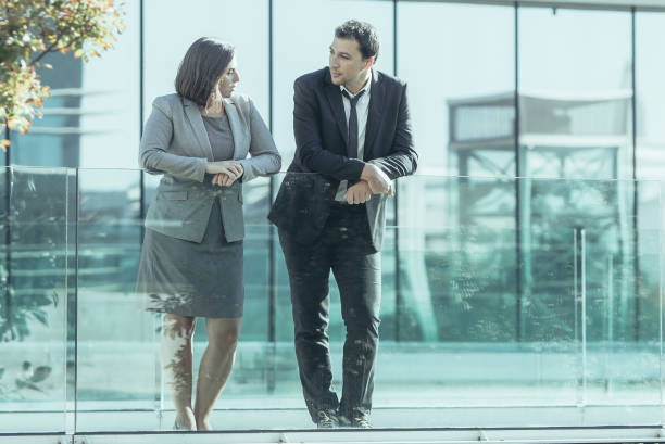 istock Serene calm business colleagues leaning on glassy railing 1061660930