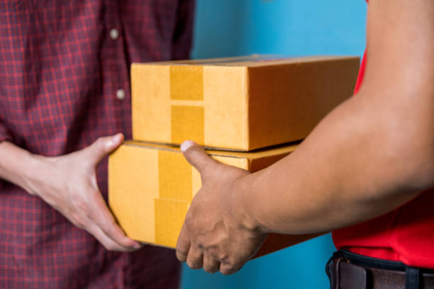 istock Male hand accepting a delivery of boxes from deliveryman. 1061660976