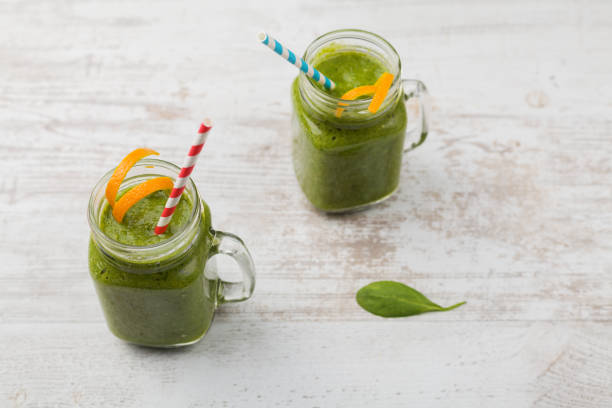 istock Vegetable and fruit cocktail, served in a jar, with fresh citrus and spinach. 1061660996