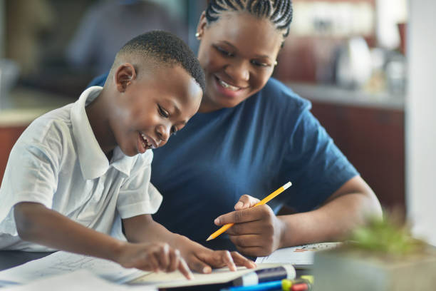 istock Smiling boy is pointing at book to mother 1061661354