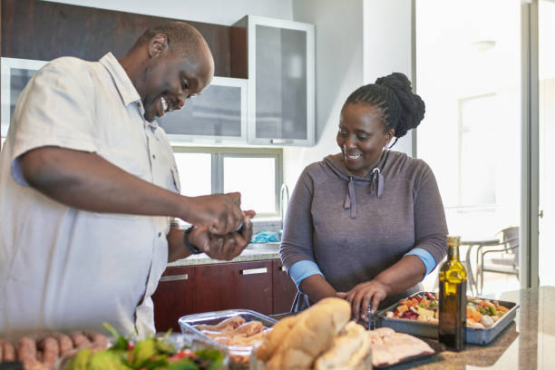 istock Senior couple preparing meal in kitchen at home 1061661494