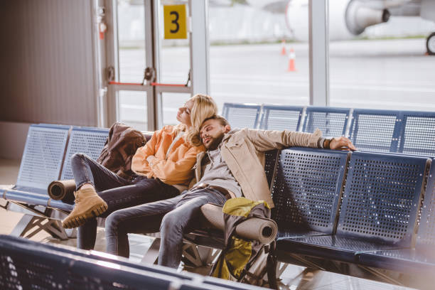 istock young couple sleeping while sitting together and waiting for flight in airport 1061661752