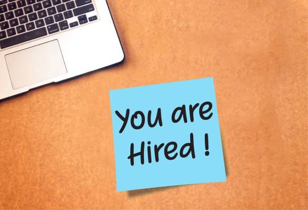 istock You are Hired on sticky note and laptop on table 1061663370