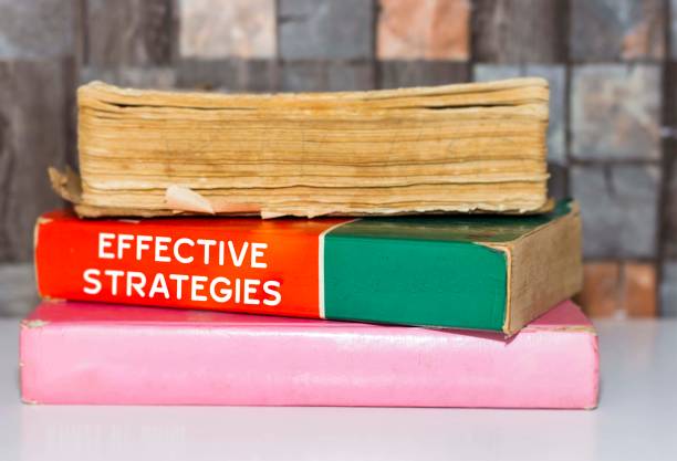 istock effective strategies - Business Book Title on wooden white table 1061668268